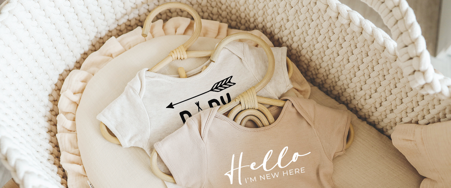Personalised baby bodyvests in a crib